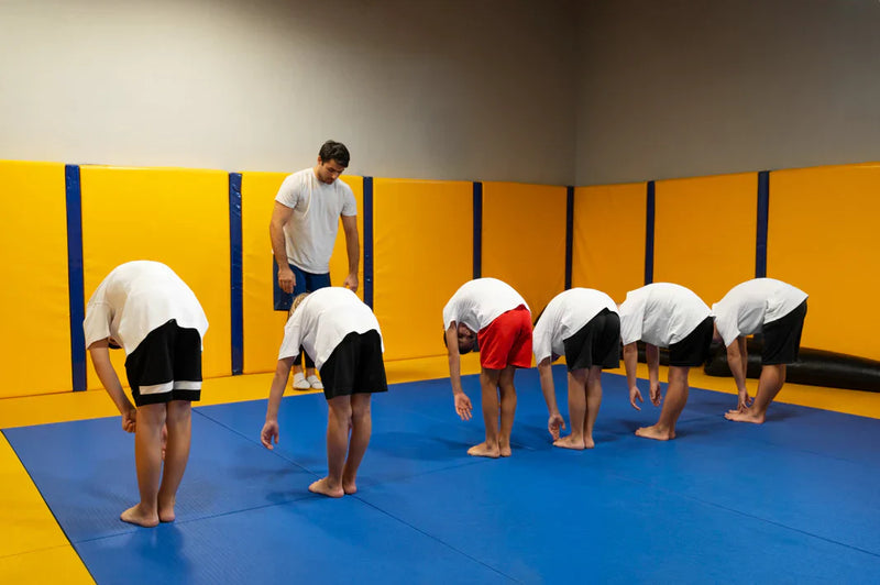 Gi jiu jitsu practitioners training inside a Brazilian Jiu Jitsu academy